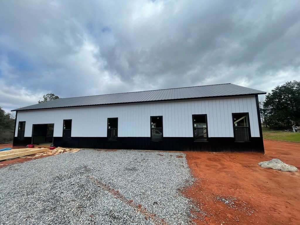 A black and white metal building under construction.