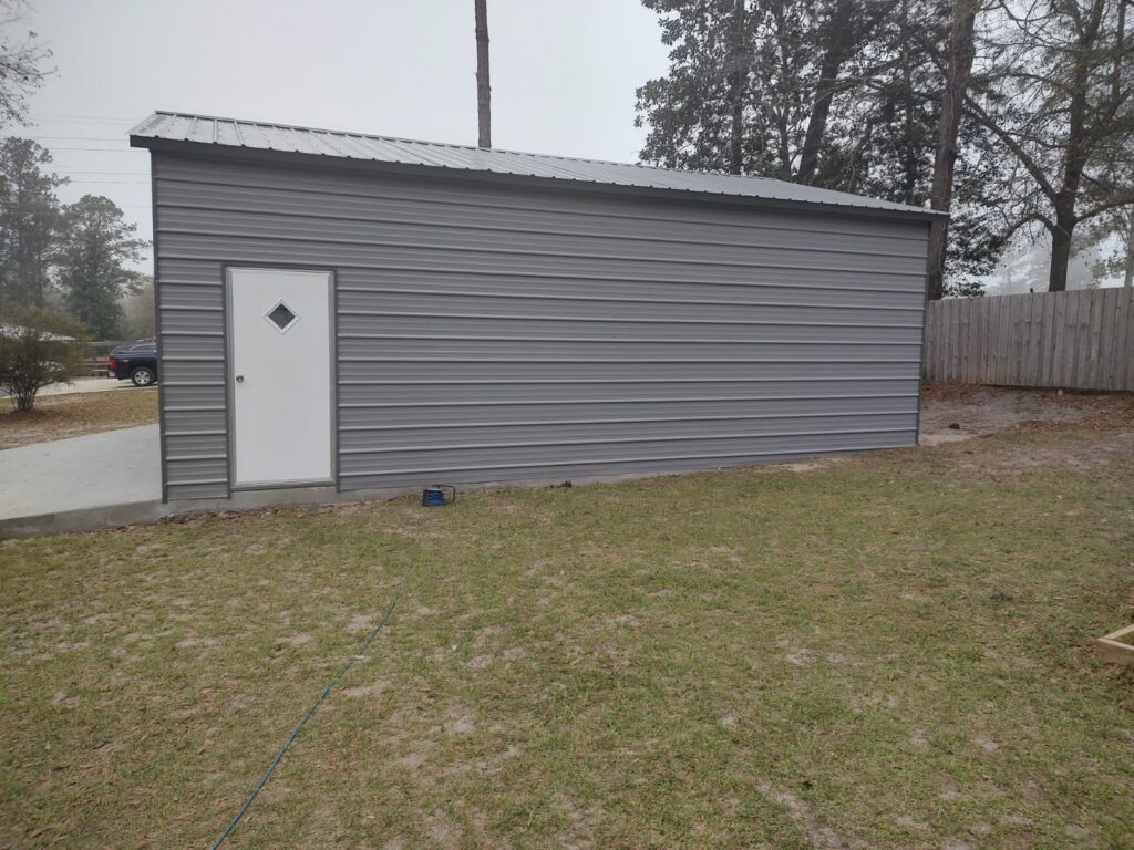 Gray metal building with white door.